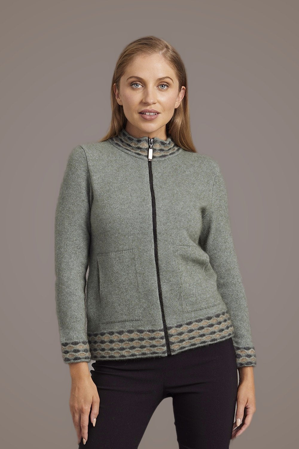 Woman wearing the Wave Trim Zip Possum Merino Cardigan in Mint by McDonald against a plain background