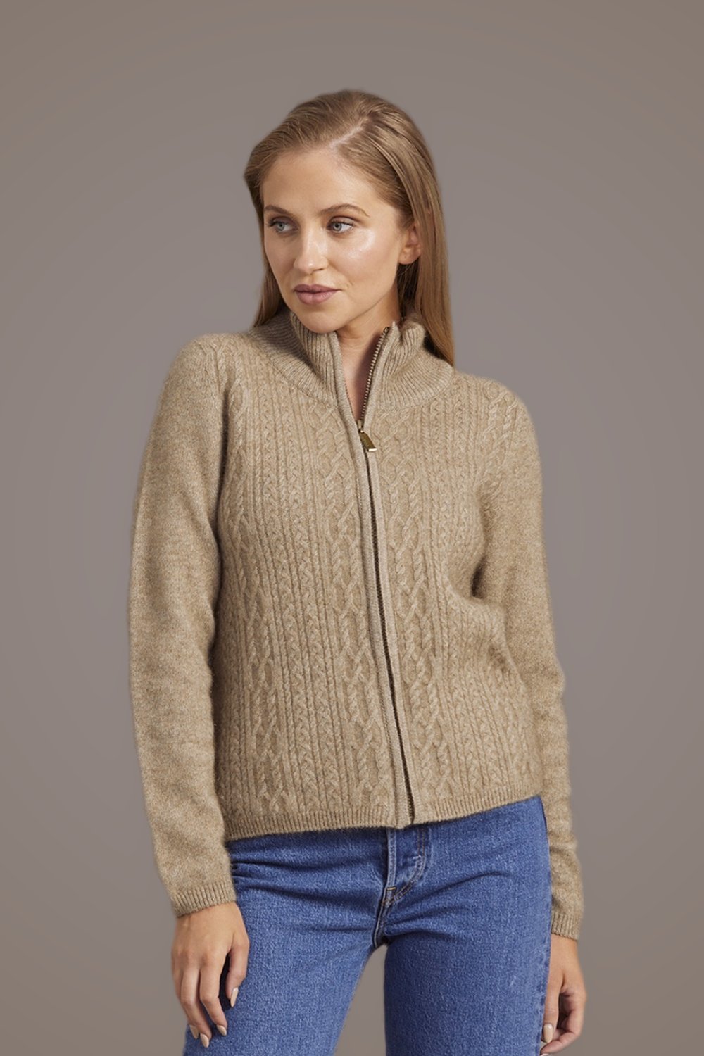 Woman wearing the Cable Zip Possum Merino Jacket in Mocha by McDonald against a plain background