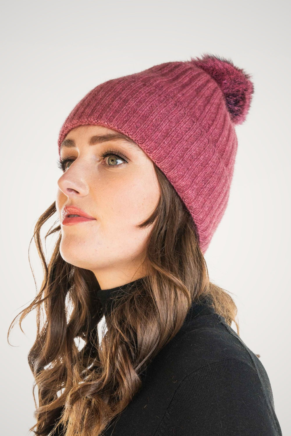 Woman Fur Pom Pom Possum Merino Beanie in Rose/Wildberry by Koru on a white background