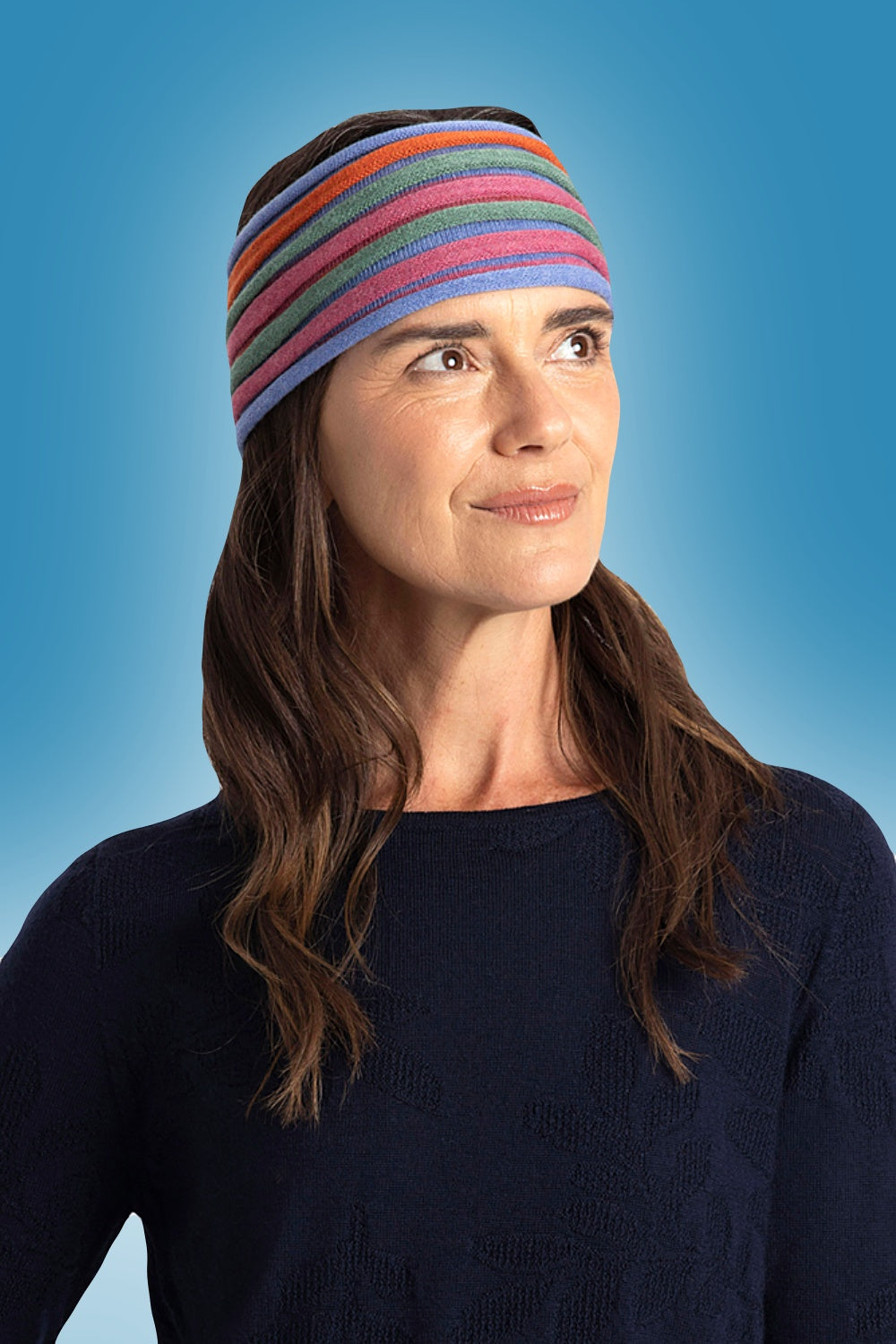 Woman wearing the Multi Stripe Merino Headband in Marble by Royal Merino against a blue background