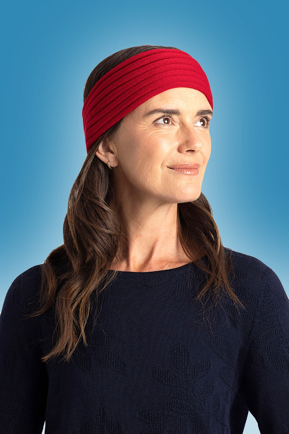 Plain Merino Headband in Tamarillo by Royal Merino against a blue background