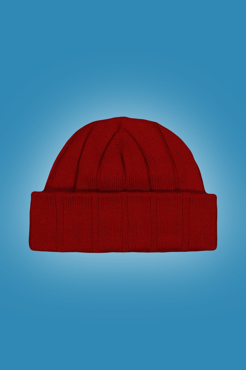 Rib Merino Beanie in Tamarillo by Royal Merino on a blue gradient background