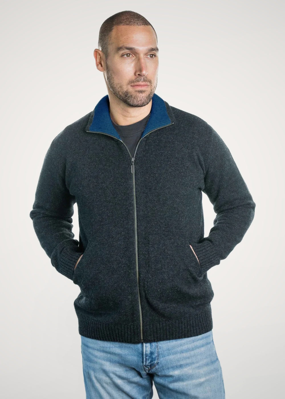 Man wearing the Zip Possum Merino Jacket in Black Marl/Marine by Trilogy against a white background