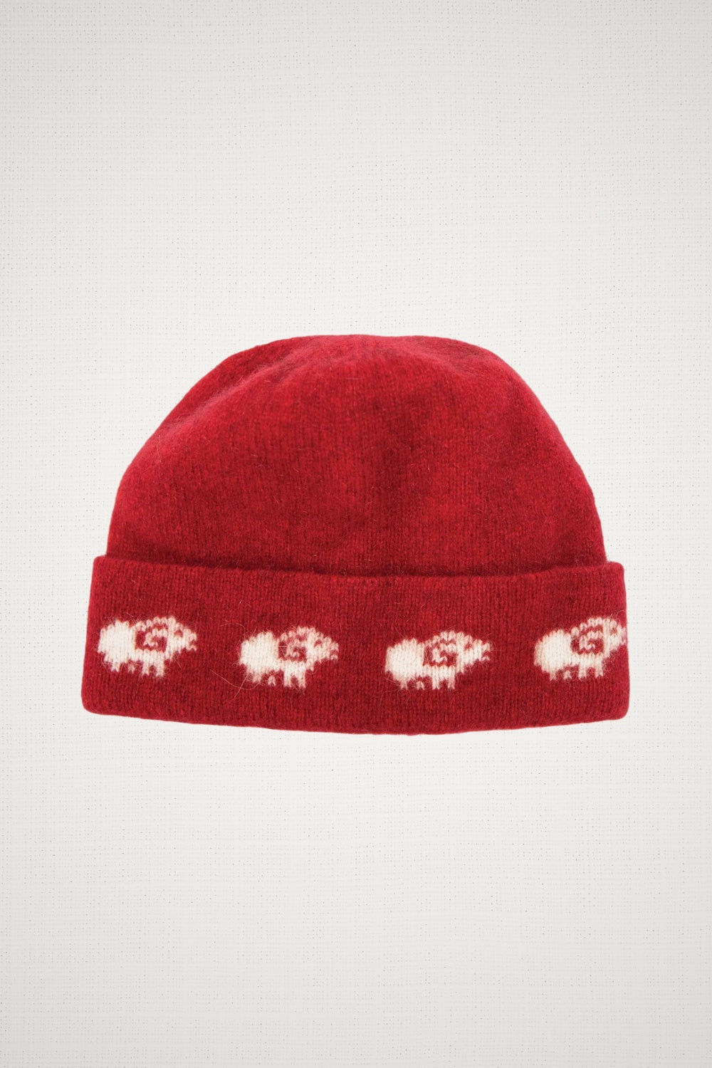 Sheep Possum Merino Beanie in Rata by Koru on a white background