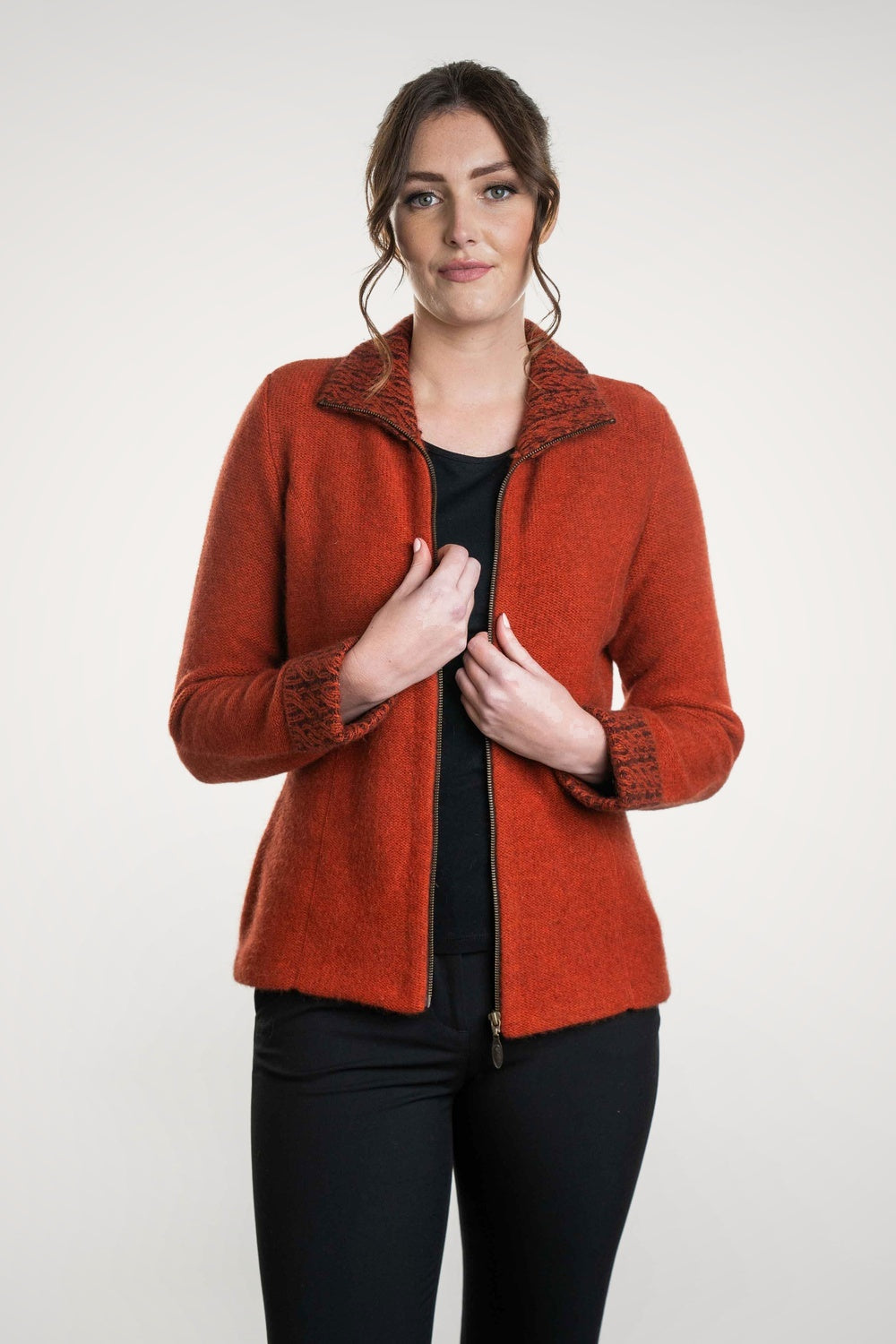 Woman wearing the Two Tone Possum Merino Jacket in Sienna/Black by Koru unzipped, on a white background