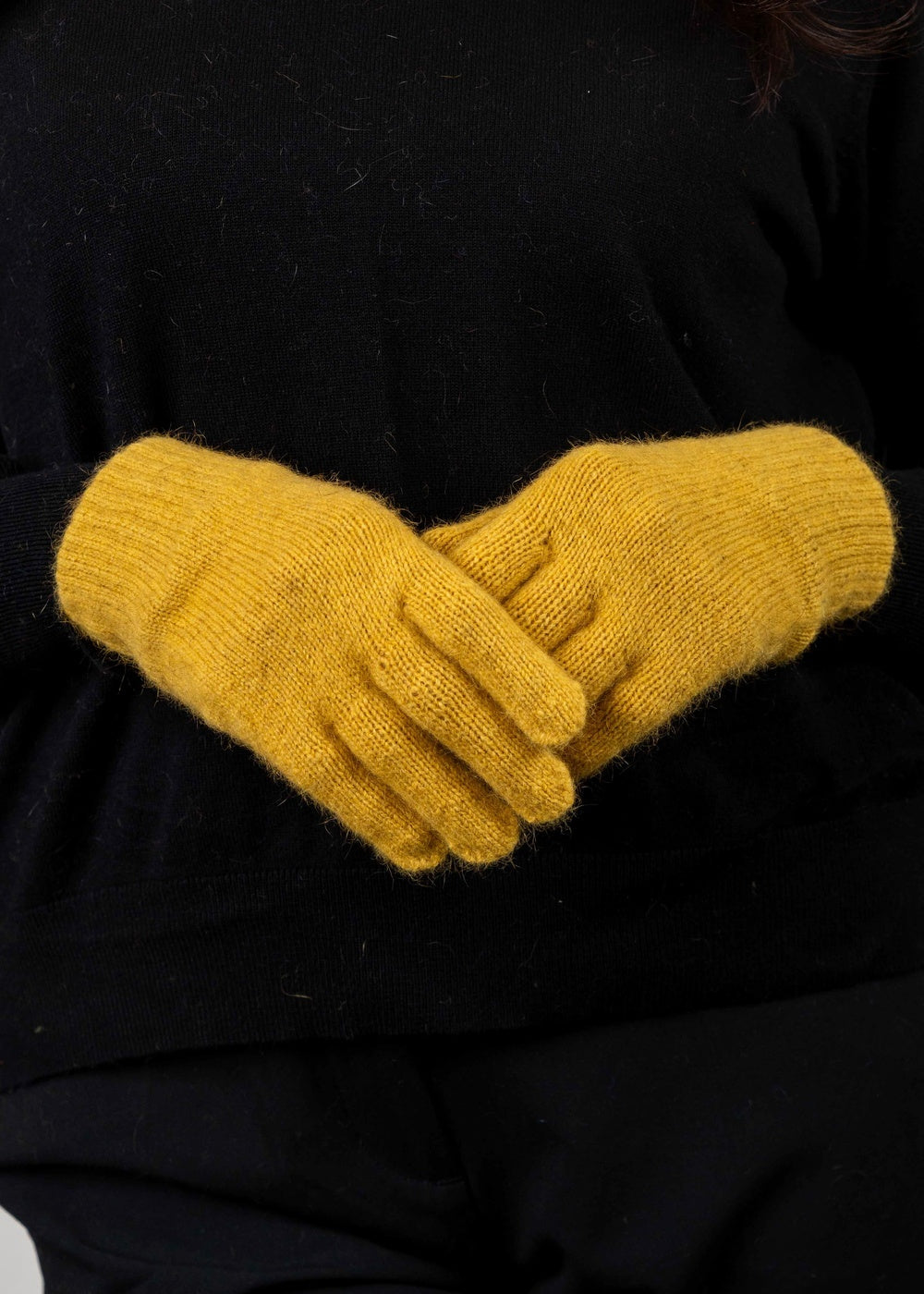 Person wearing the Plain Possum Merino Gloves in Kowhai by Koru