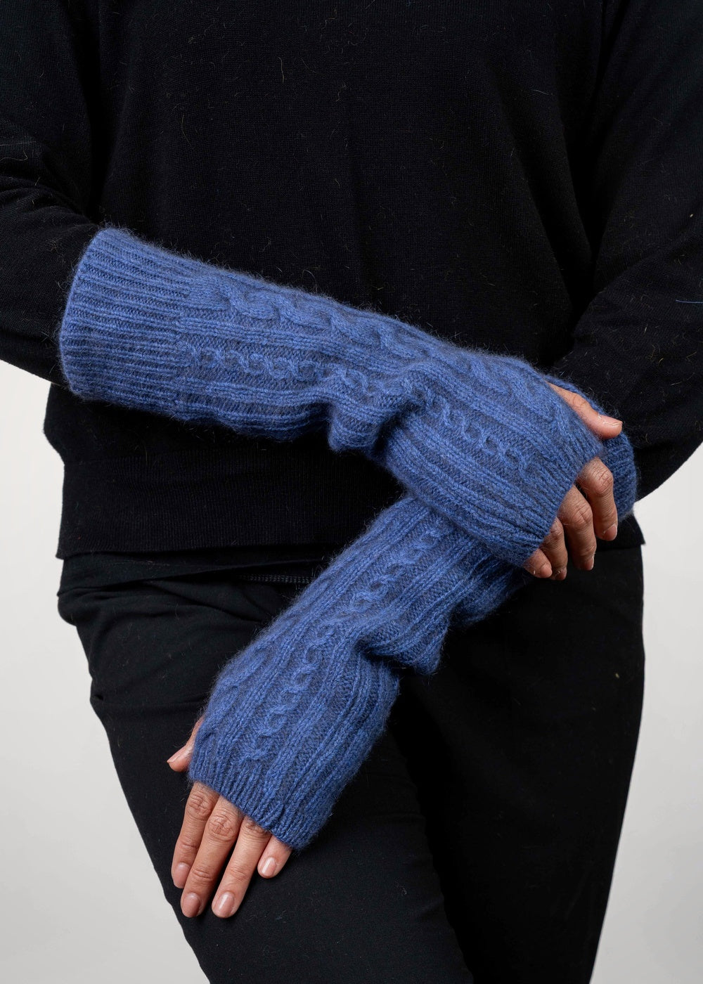 Person wearing the Cable Possum Merino Glovelets in Periwinkle by Koru