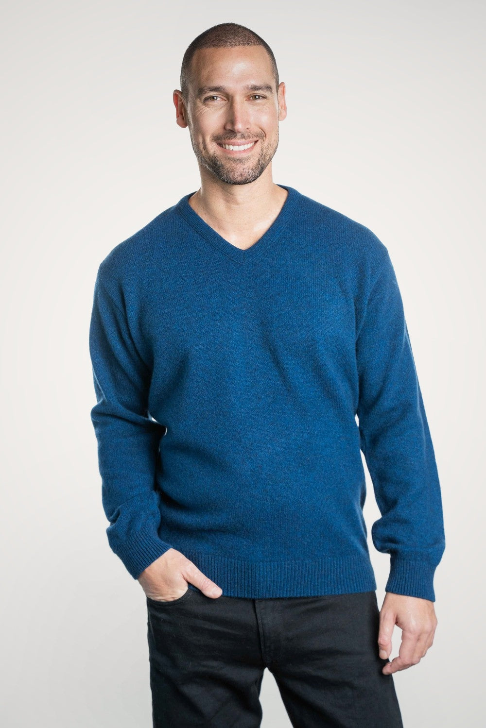 Man wearing the V Neck Possum Merino Jumper in Admiral by Trilogy against a white background